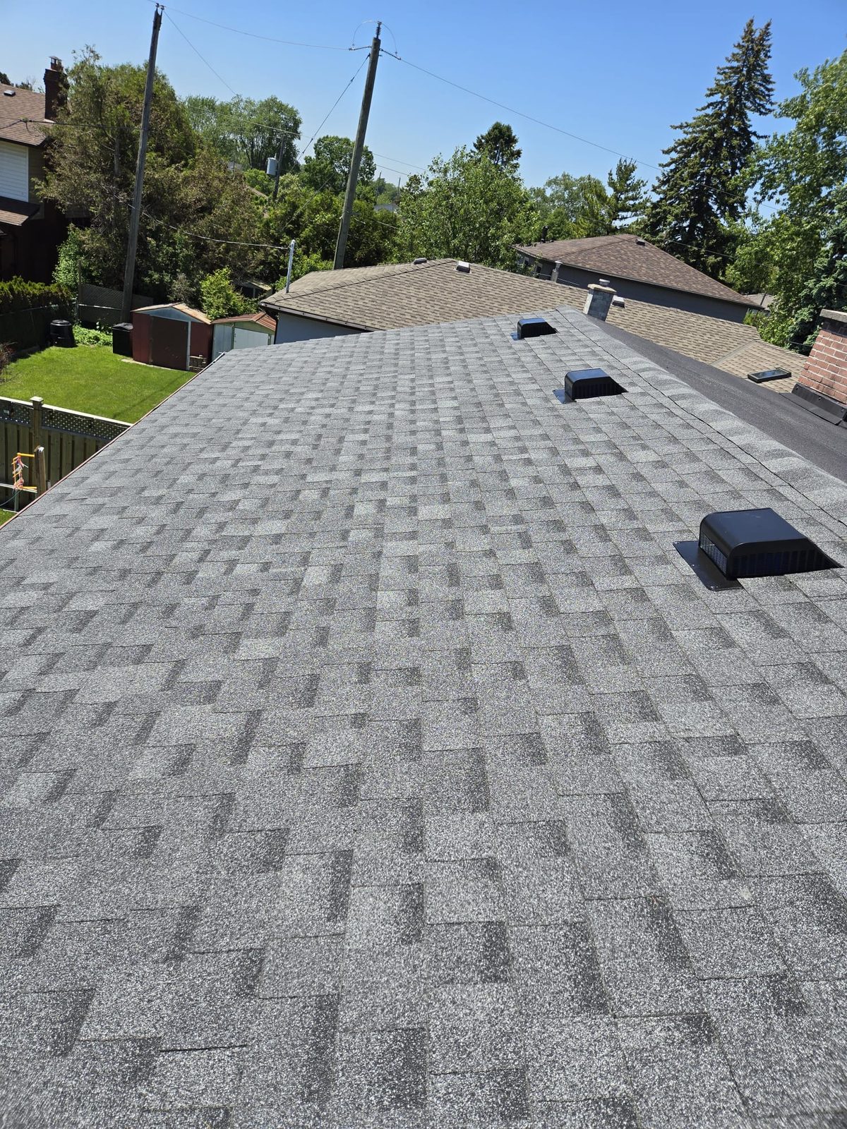 Grey shingle roof with a clean roof edge and black vents