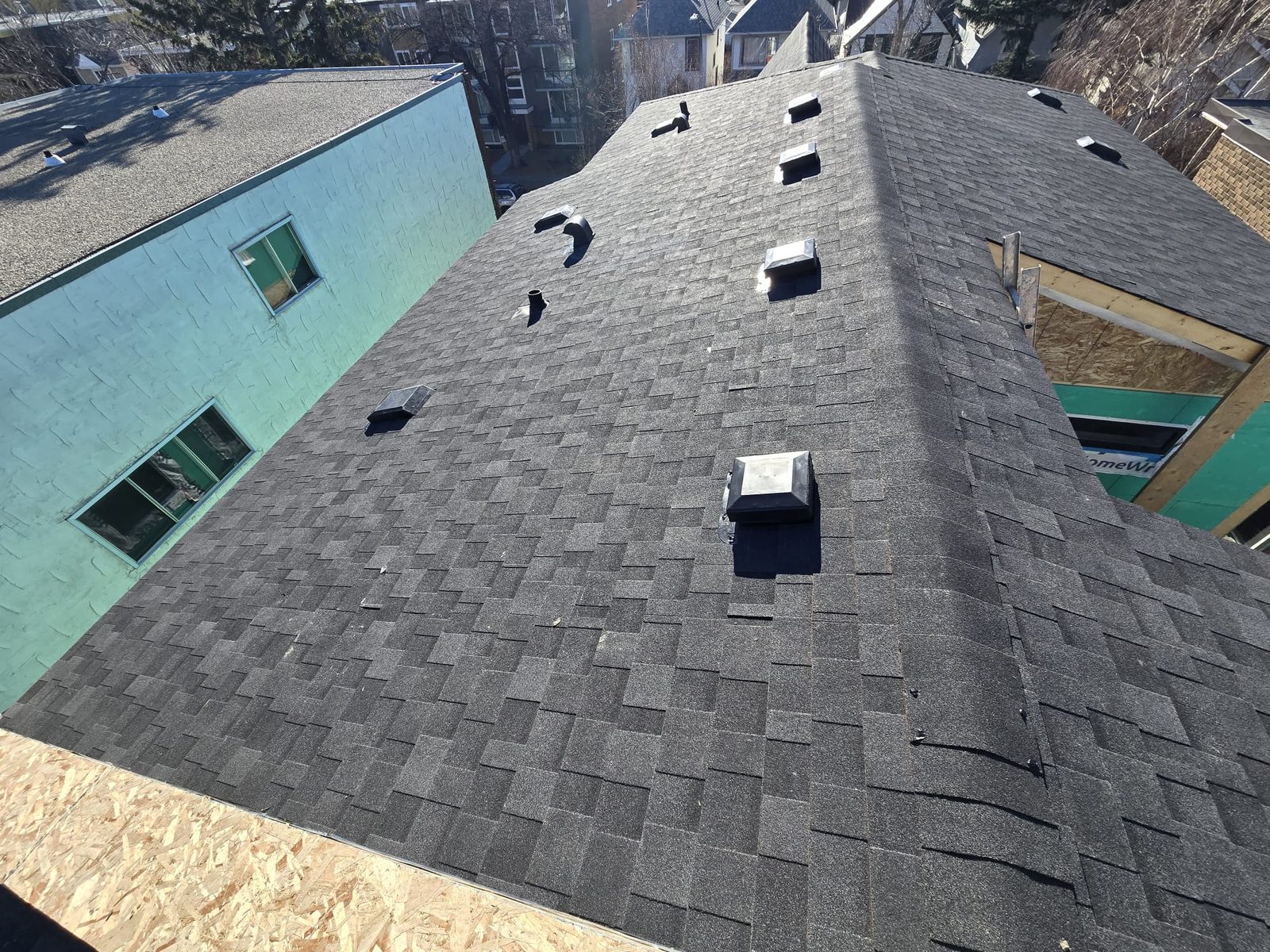 Dark grey shingle roof with several roof vents